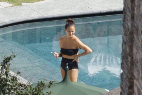 Chrissy Teigen – Seen by a swimming pool in Lake Como
