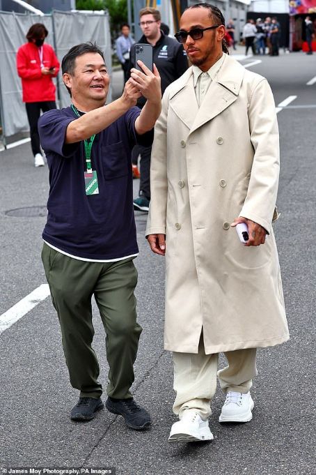 Lewis Hamilton looks trendy in a cream trench coat ahead of Japanese F1 Grand Prix - after vowing to 'come back stronger' after Singapore defeat
