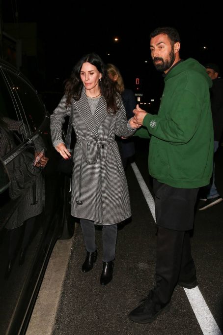 Courteney Cox – In a black and white long coat at Giorgio Baldi