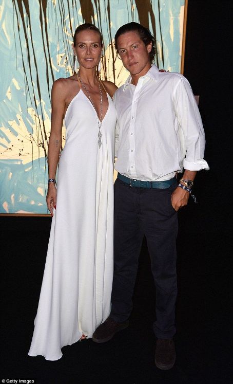 Heidi Klum cuts an elegant figure in low-cut white gown as she joins toyboy Vito Schnabel at Leonardo DiCaprio charity gala