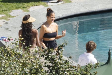 Chrissy Teigen – Seen by a swimming pool in Lake Como