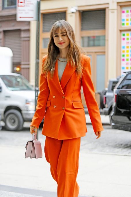 Lily Collins – Arrives at the Crosby Hotel in a fashionable red pantsuit in New York