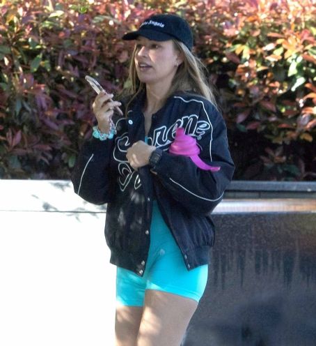 Zara McDermott – Wearing a blue lycra bodysuit and Converse Trainers while out in London