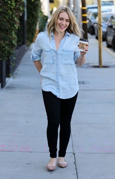Hilary Duff carries a coffee as she has her bags carried to her car after doing some shopping