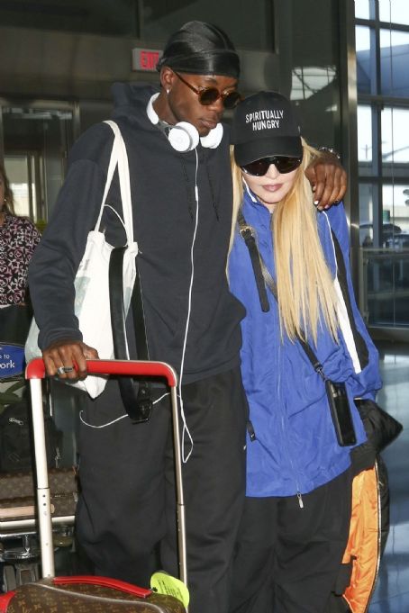Madonna, cuts a low-key figure as she is supported by her son David Banda at JFK Airport in New York