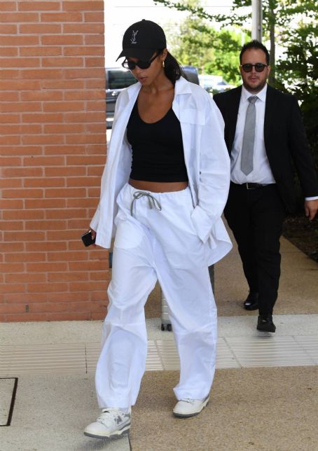 Laura Harrier – In a white tracksuit arriving at Venice Film Festival