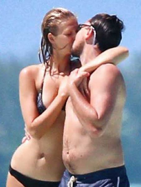 Leonardo DiCaprio goes shirtless while holding hands with his bikini-clad girlfriend Toni Garrn at the beach last week in Bora Bora. (April 14)
