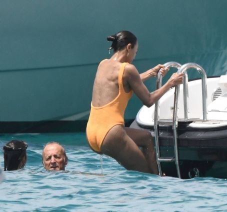 Zoe Saldana – Is Seen in a orange swimsuit in Sardinia