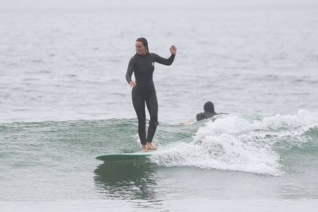 Leighton Meester – gets on her surfboard in Santa Monica
