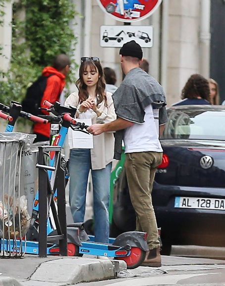 Lily Collins – With new boyfriend Charlie McDowell go for a ride in scooter in Paris