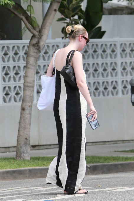 Dakota Fanning – Wearing bold stripe dress on Melrose in West Hollywood