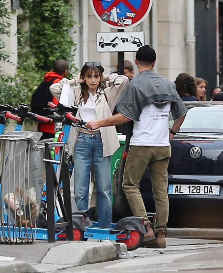 Lily Collins – With new boyfriend Charlie McDowell go for a ride in scooter in Paris
