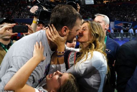 Gisele Bündchen's kiss for her Super Bowl king! Tom Brady's model wife celebrates Patriots win as he vows to play on despite her calls for him to retire