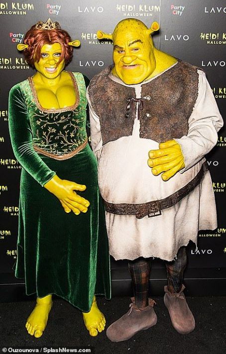 Heidi Klum, 45, and toyboy beau Tom Kaulitz, 29, make a grand entrance in elaborate Fiona and Shrek costumes as they welcome a star-studded crowd to her annual Halloween party in NYC