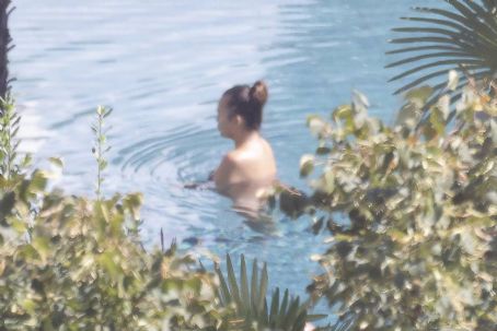Chrissy Teigen – Seen by a swimming pool in Lake Como