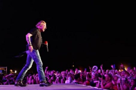 INDIO, CALIFORNIA - APRIL 30: Axl Rose of Guns N' Roses performs onstage with Carrie Underwood during Day 2 of the 2022 Stagecoach Festival at the Empire Polo Field