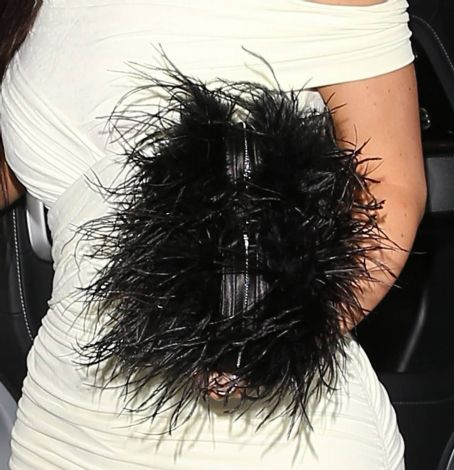 Kylie Jenner – In a white dress and a black fluffy handbag by Alexander Wang at Casa Vega