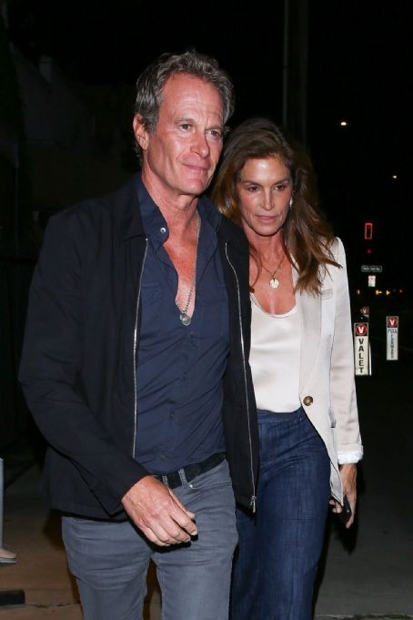 Cindy Crawford looks ultra-chic in a satin top and blazer as she heads out for a romantic dinner with husband Rande Gerber in Santa Monica